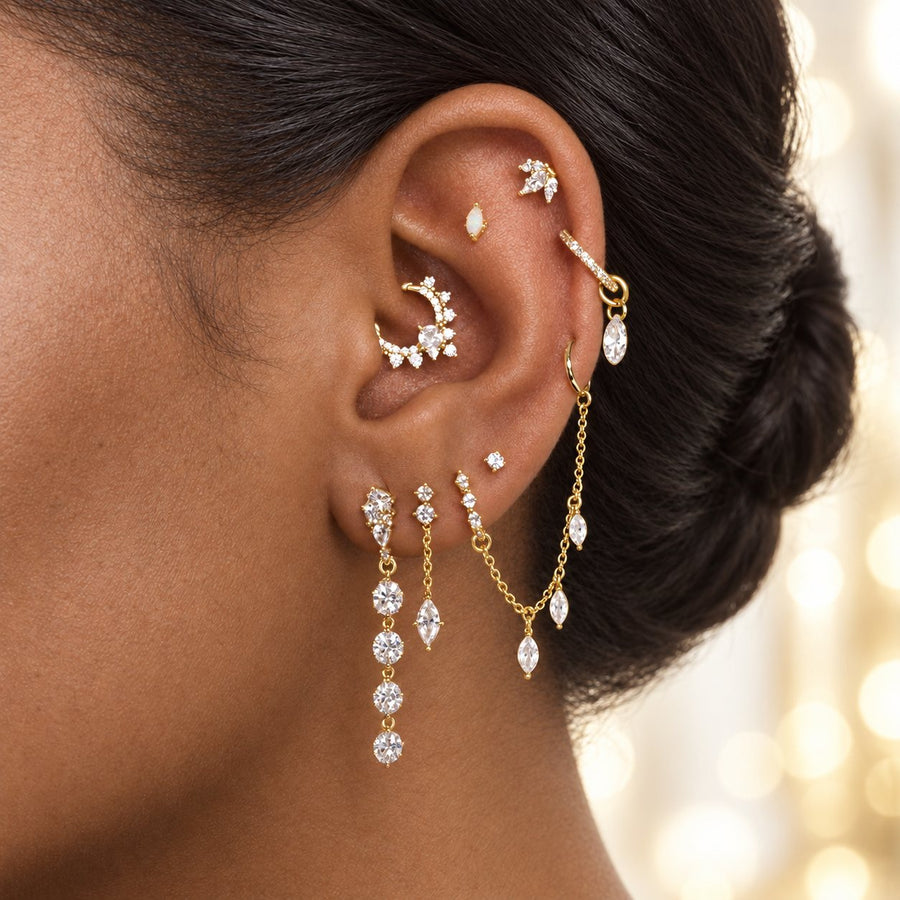 Gold ear stack: helix hoop with a marquise drop, daith hoop, chain with drops and lobe pieces
