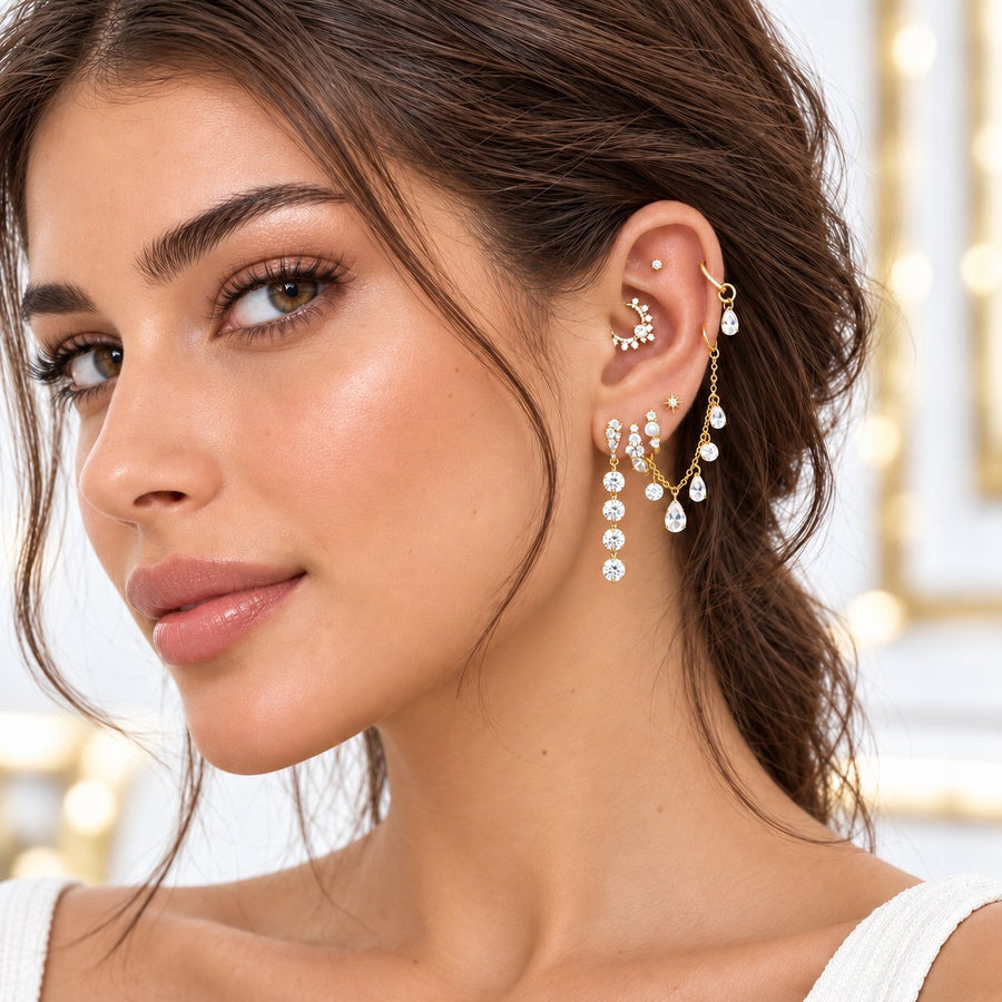 Gold ear stack with a daith hoop and long lobe drops